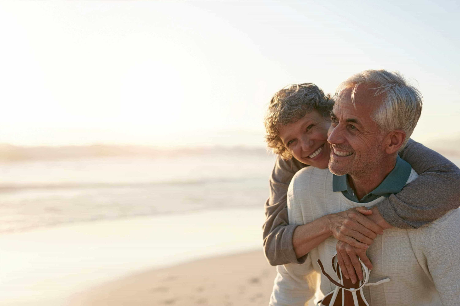 Happy retired couple on vacation at the beach