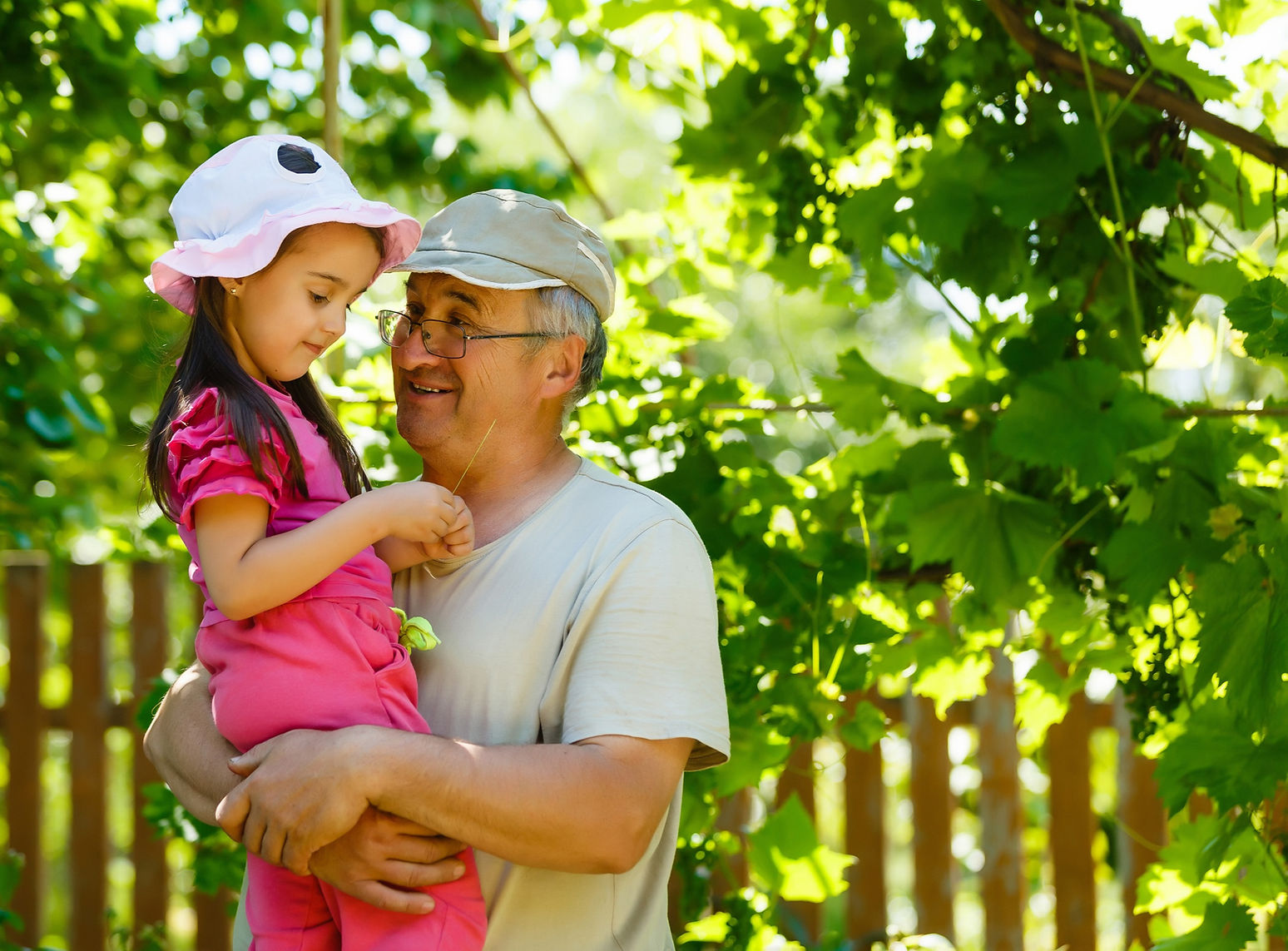 Retired Grandfather Holding Grandchild